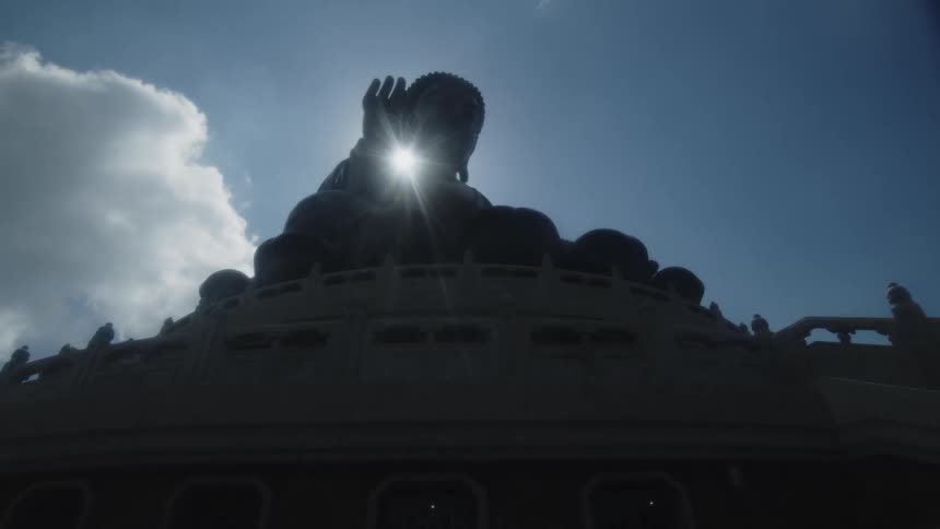 A large buddha statue is at the top of the temple