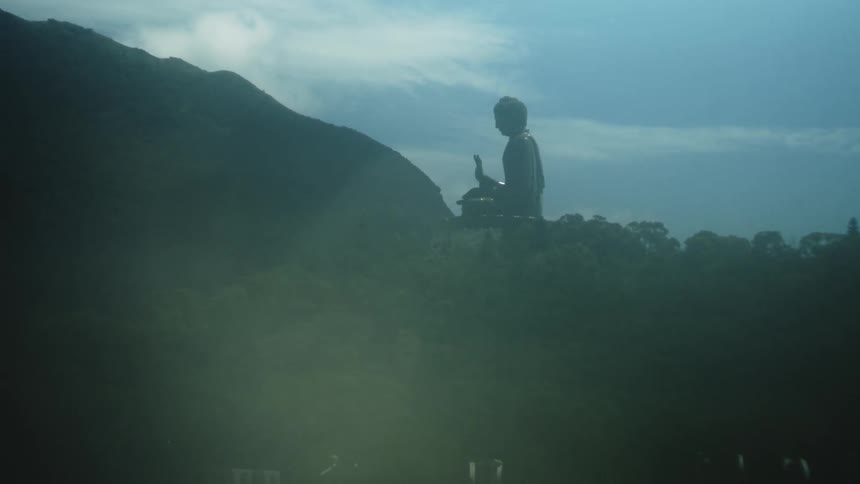 Monumental silhouette rests among mountains and forest wrapped in the mist of a contemplative moment