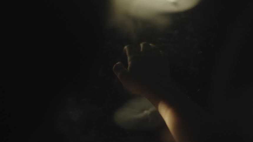 The child is reaching his hand out