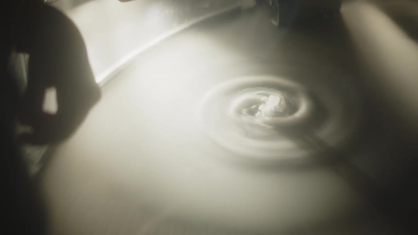 Dough spins in a spiral at the center of an illuminated surface