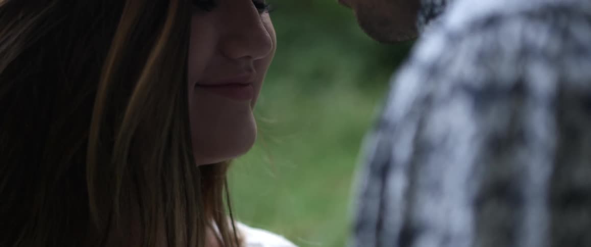 A man and woman nuzzle their noses