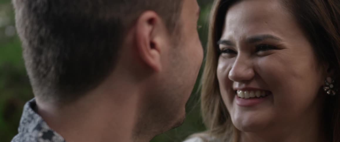 Two people talk and the man kisses her forehead
