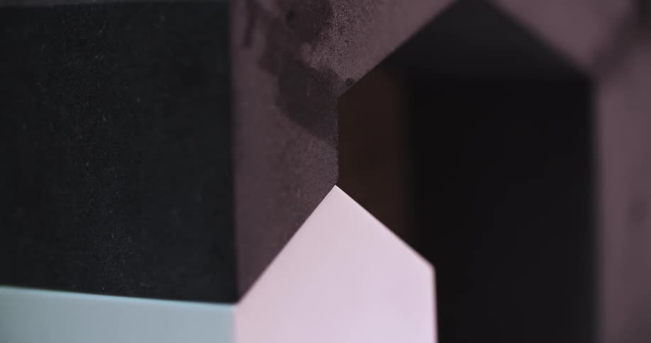 Detail of a junction between geometric pieces of different materials and colors