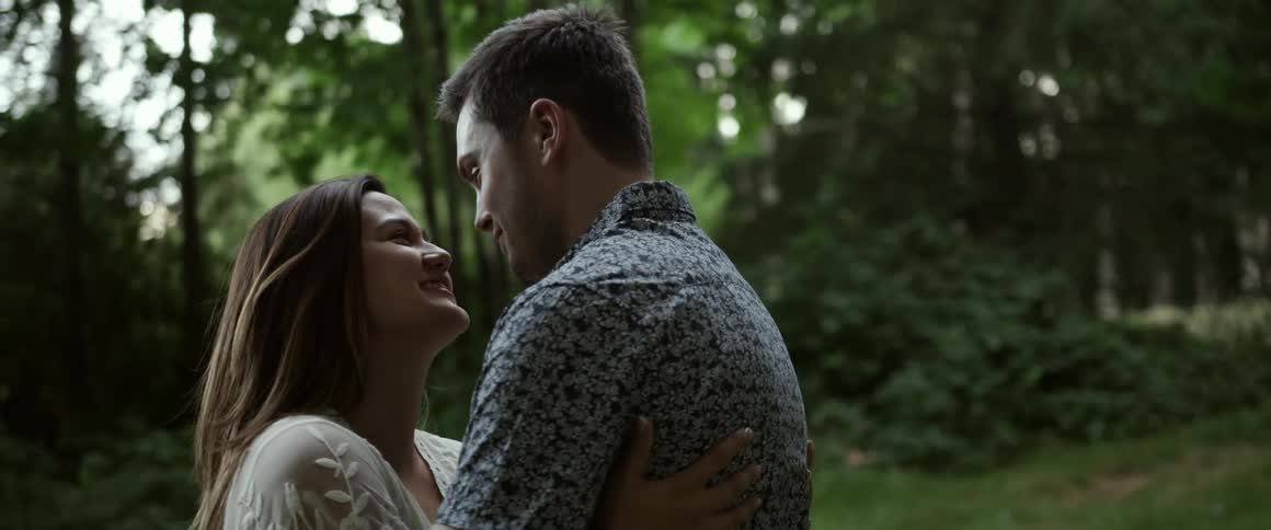 Man and woman hugging and kissing outside
