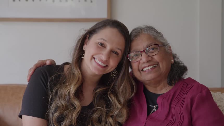 Close up portrait of a young woman with an elderly woman indoors during daytime
