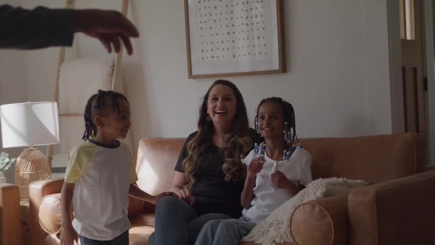 A family playing a game together in the living room