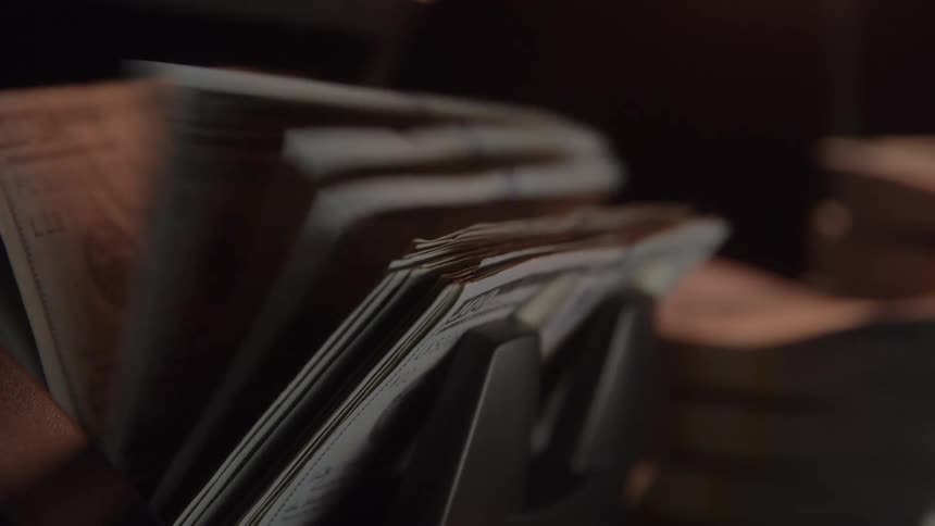 Dollar bills being quickly counted by an automatic machine