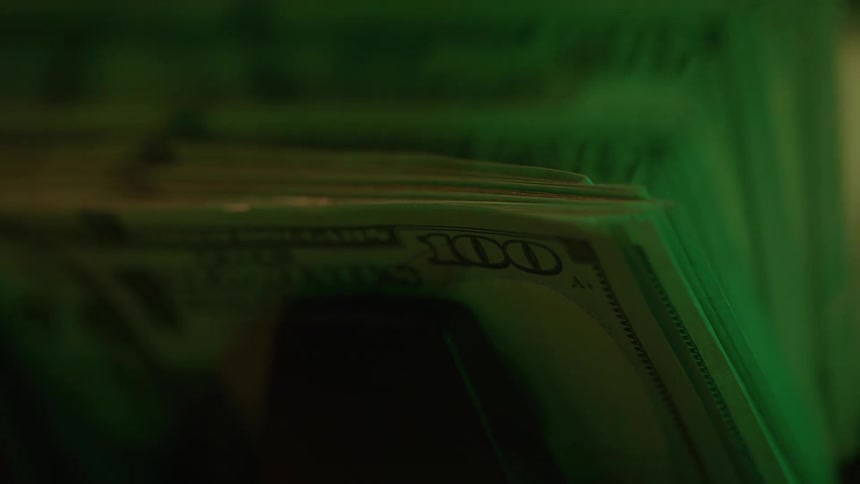 The currency counting machine stacks the bills as it counts