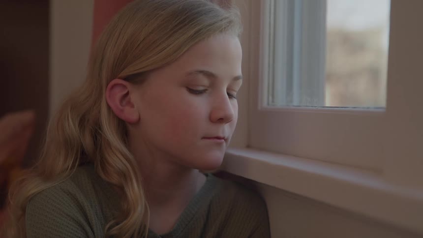 A girl looks out the window