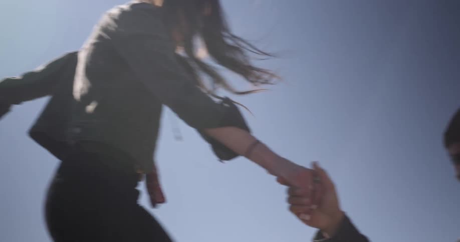 Man and woman step down from high area in nature