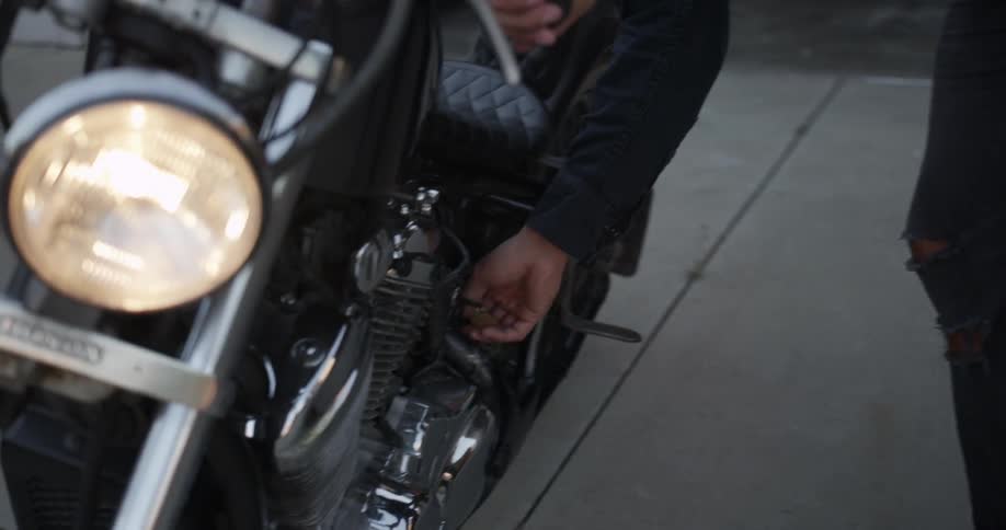 Person turns the headlight on their motorcycle