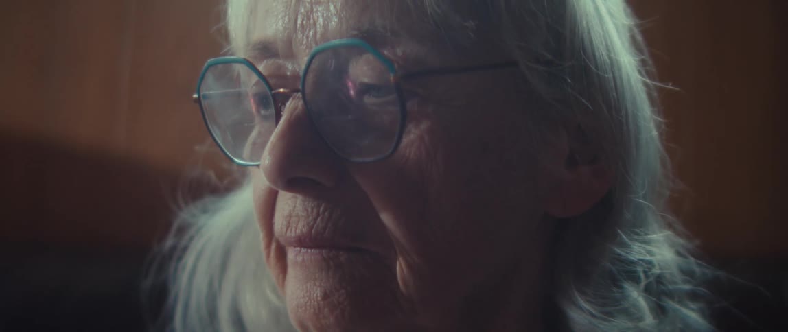 The woman is wearing large rimmed glasses