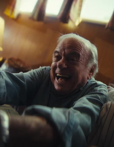 The man has a big smile while playing video games