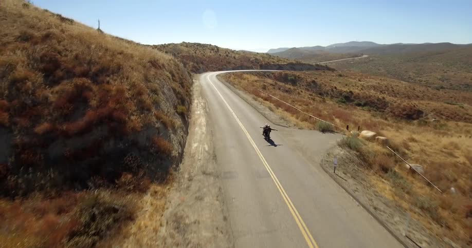 Couple on motorcycle ride down a countryside road