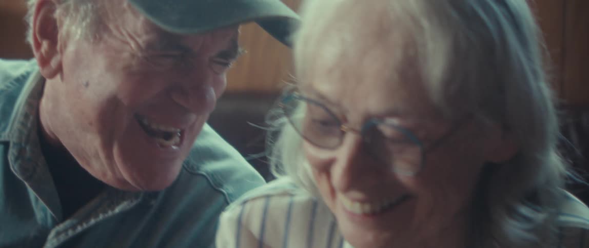 Man and woman having a good time putting together a jigsaw puzzle