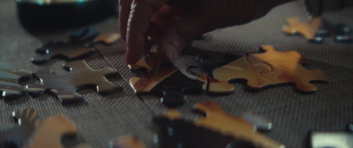 A person works on a jigsaw puzzle