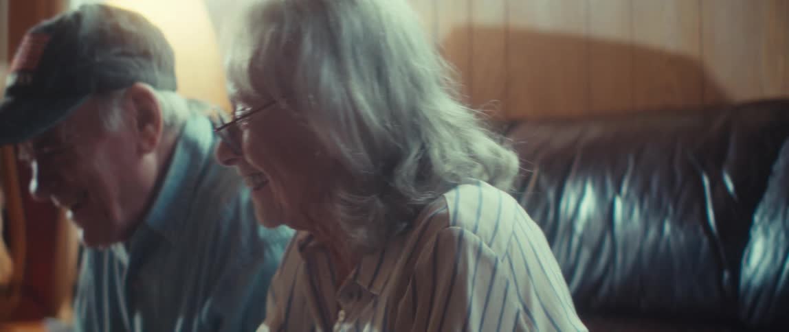 A couple happily solving a jigsaw puzzle together in a living room