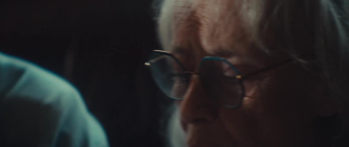 Elderly couple contemplates something together while sitting indoors