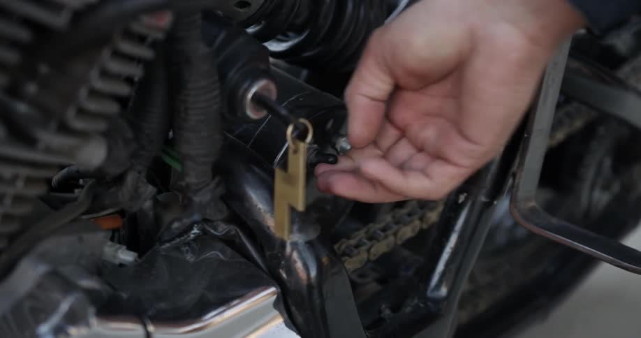 A person turning the ignition on their motorcycle