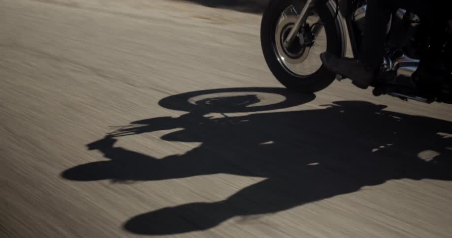 Shadow of a person riding a motorcycle