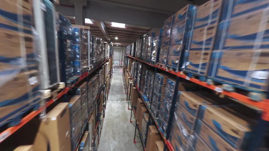 Tall industrial warehouse shelves filled with stacked boxes