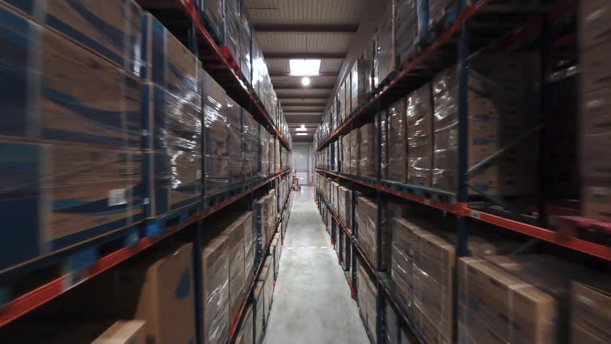 A large warehouse with shelves stacked high with boxes