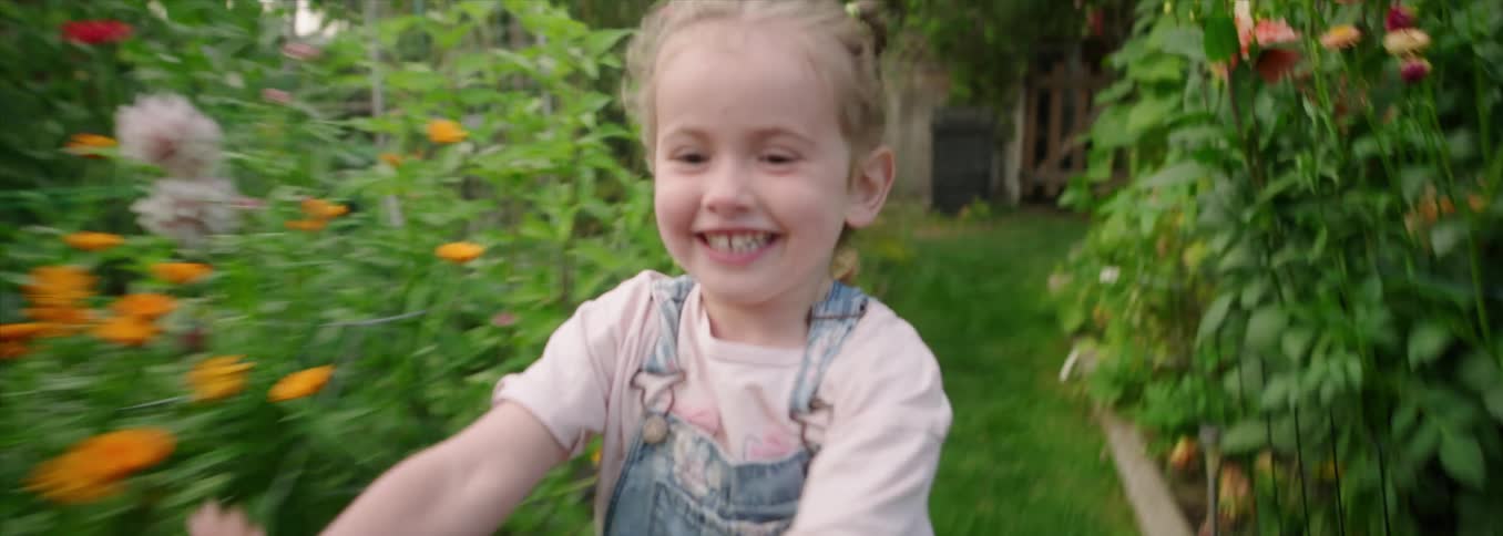 The girl runs through the garden