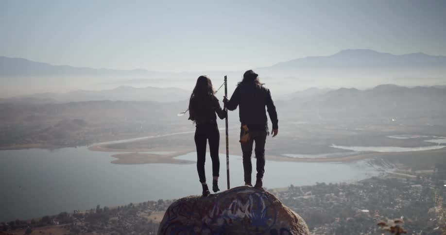 Man and woman on picturesque overlook