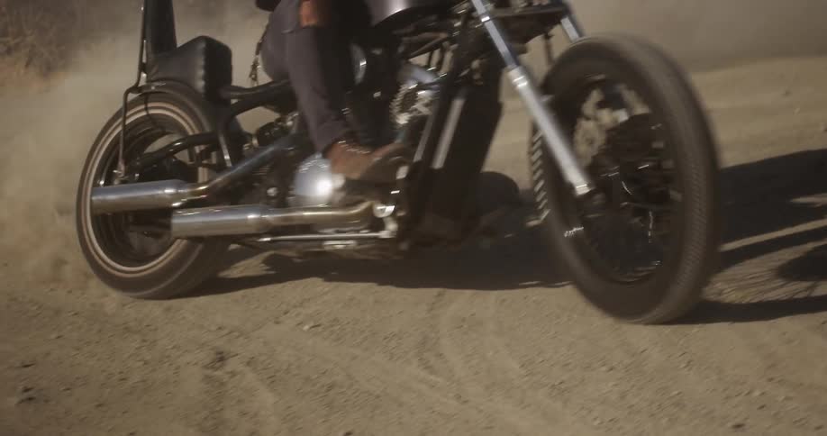 A person riding a motorcycle on a dirt road