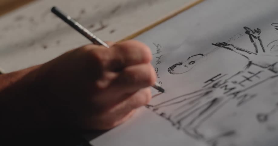 Person writes a piece of advice near the rough sketch of a person