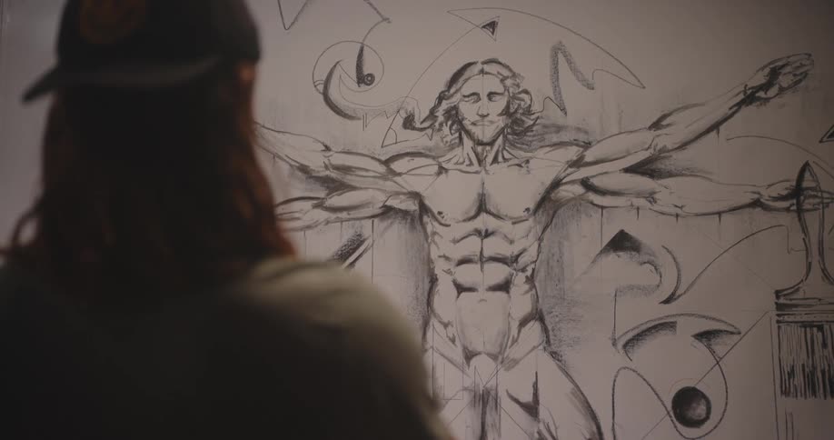Person observing a large drawing inspired by the vitruvian man with modern artistic strokes