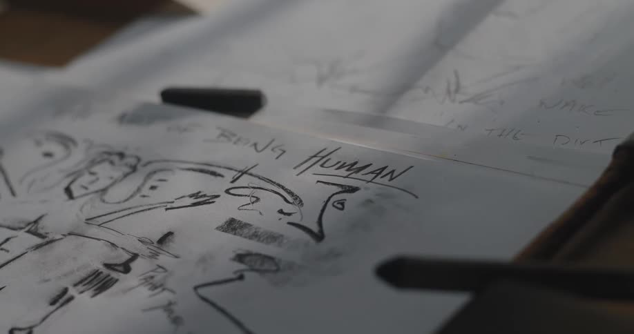Closeup of hand drawn sketches on paper in creative workspace
