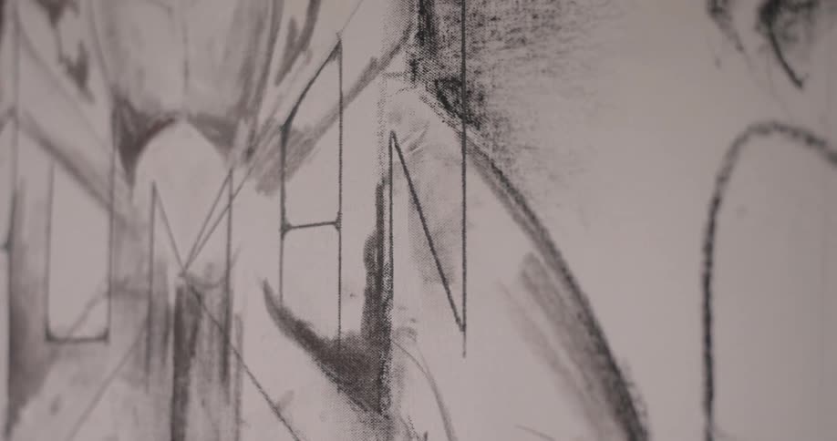 A black pen drawing on a white piece of cardboard