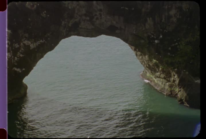 The water moves past a rock formation below