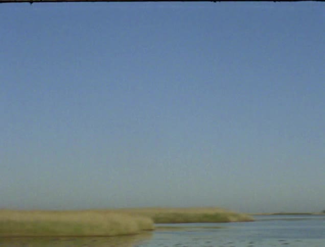 A strip of land against a blue sky