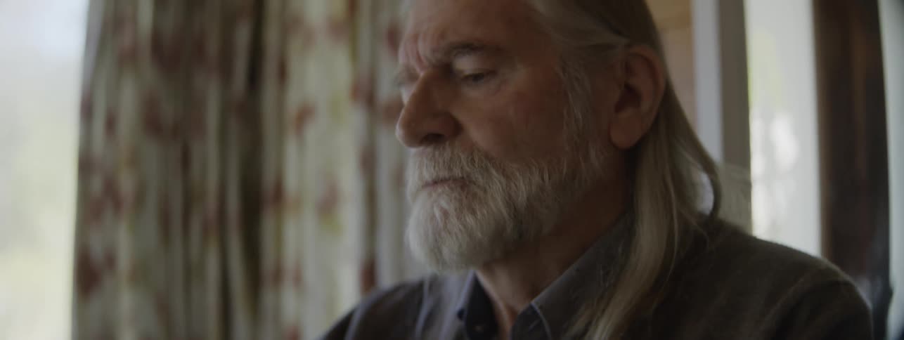 An elderly man with Parkinsons in denial about his health deteriorating while he struggles to perform everyday tasks