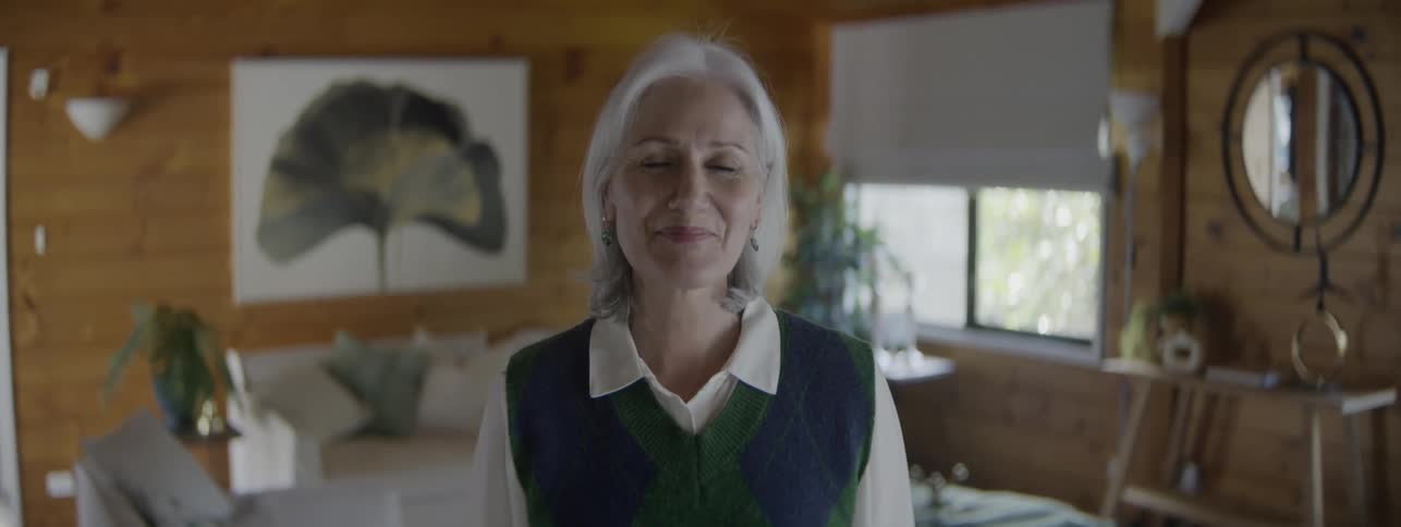 Close up portrait of a middle aged woman standing in a room during daytime