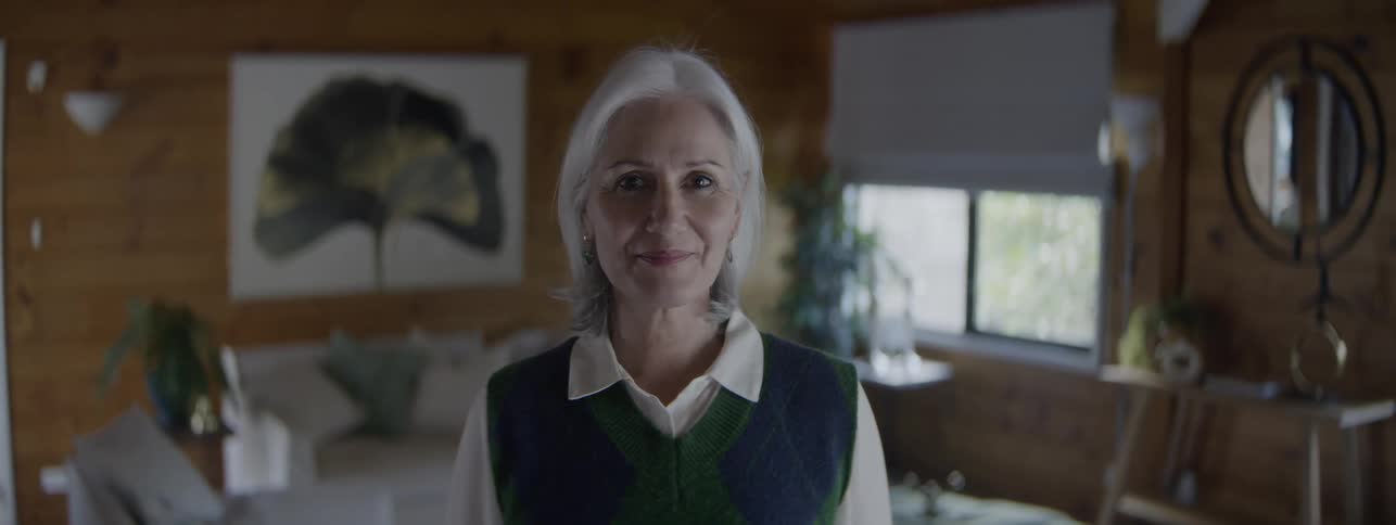 A woman smiles at the camera