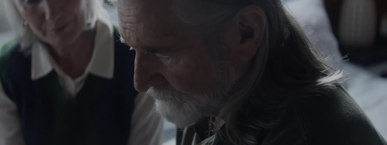 Elderly couple sitting side by side in a moment of calm
