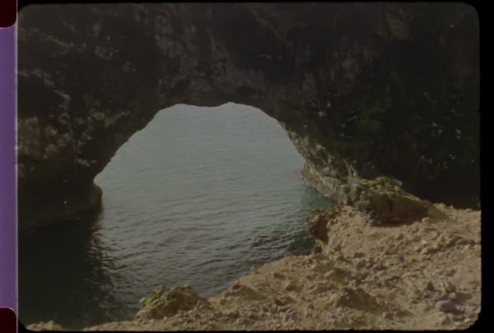 Large rock formation over a body of water