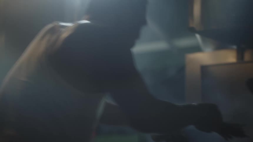 Person cooking in a pot in a dimly lit setting