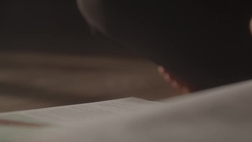 A person turns the page of a book