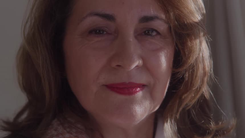 A woman smiles at the camera