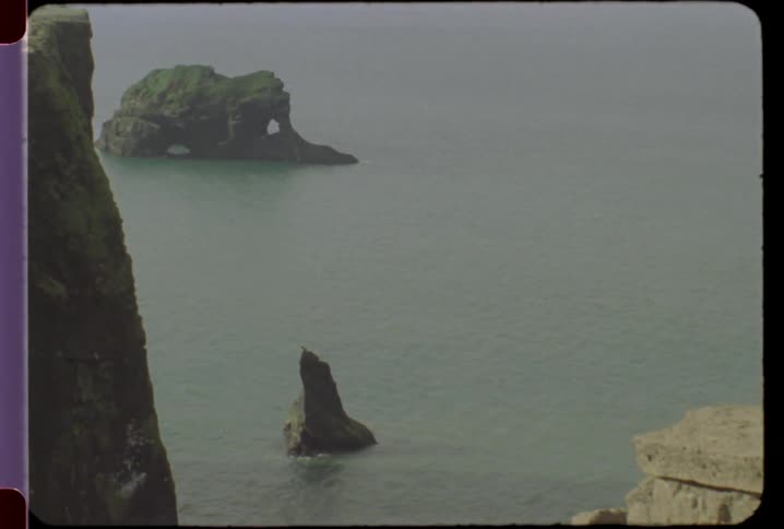 Several rock formations sticking out of the water