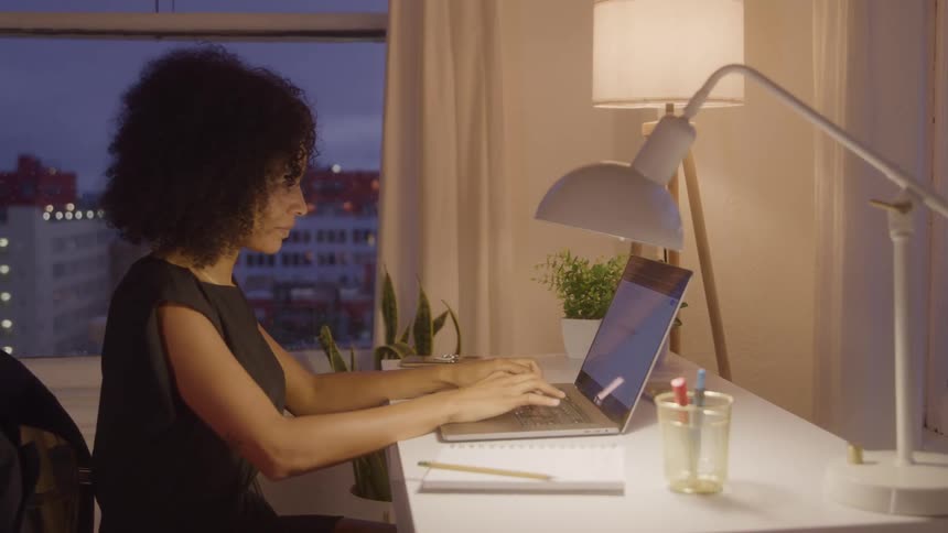 A woman typing at her computer