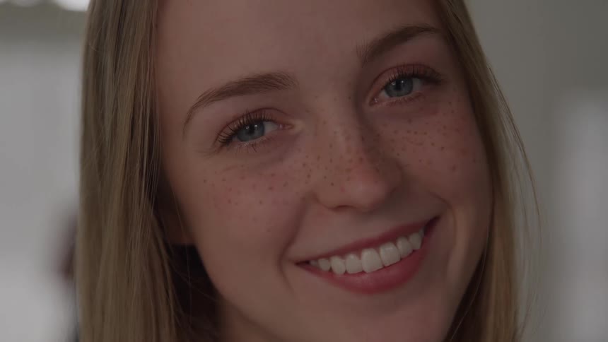 Woman smiles with a serene expression after yoga practice
