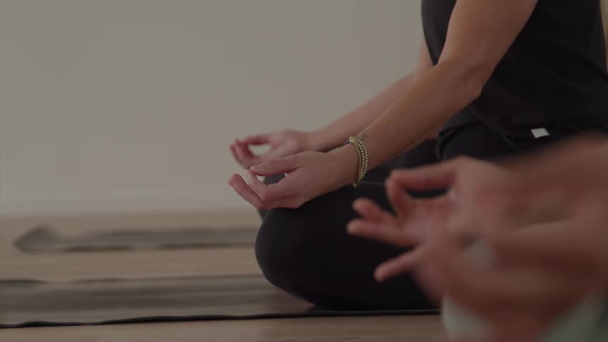 The women are meditating while sitting on the mats