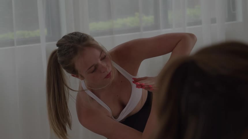 Woman keeps her hands together above her head during a yoga practice