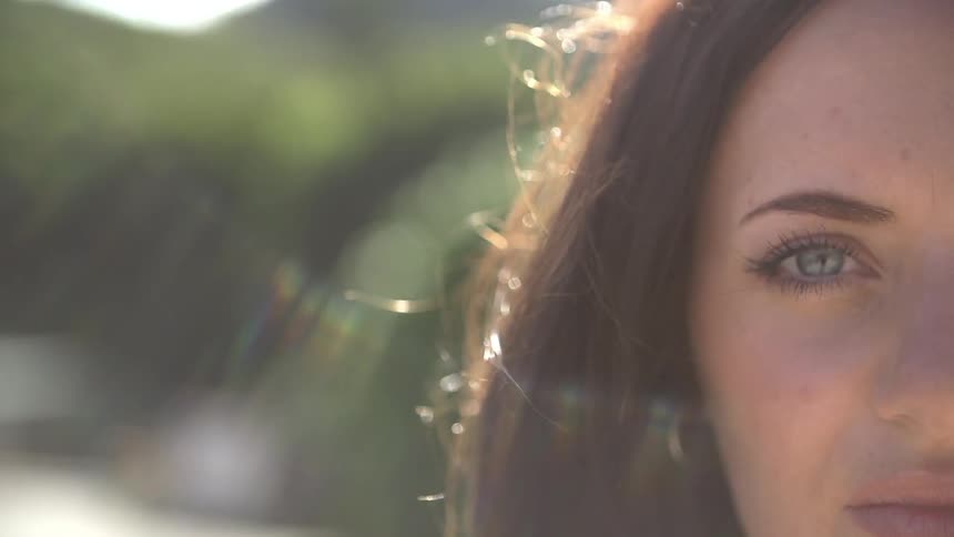 The wind rustles a woman's hair