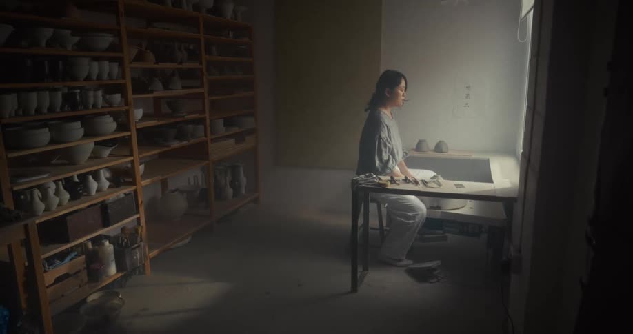 The woman is meditating in the room